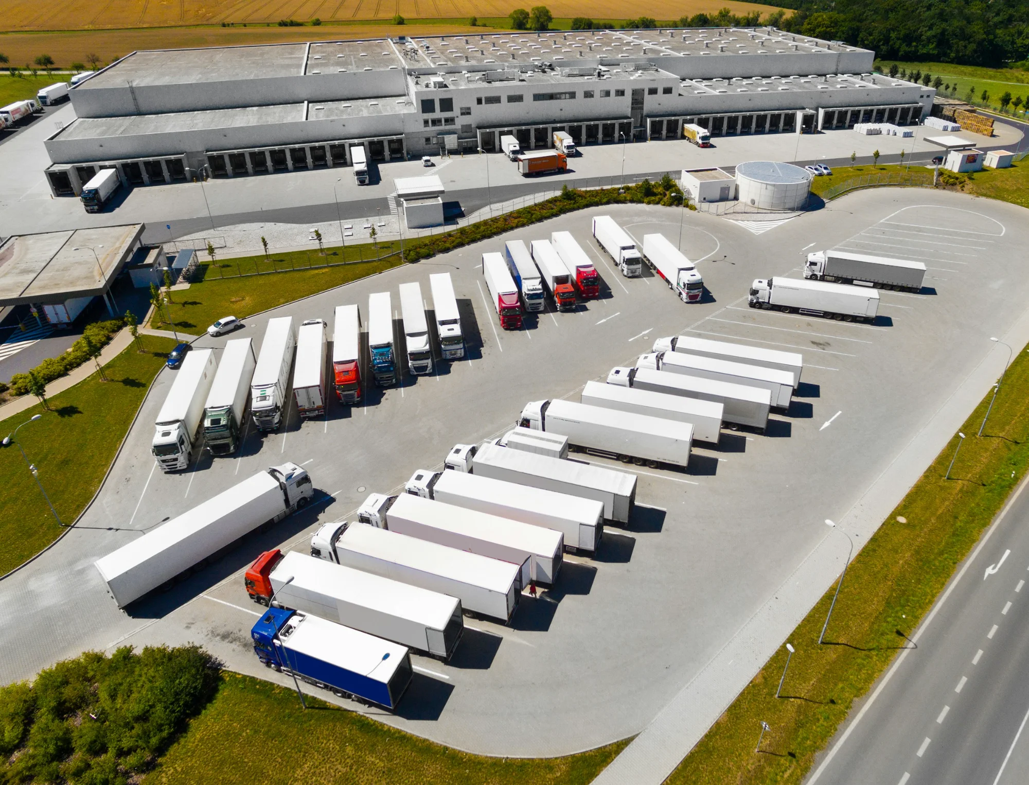Industrial outdoor storage property with trailers parked outside a logistics warehouse.